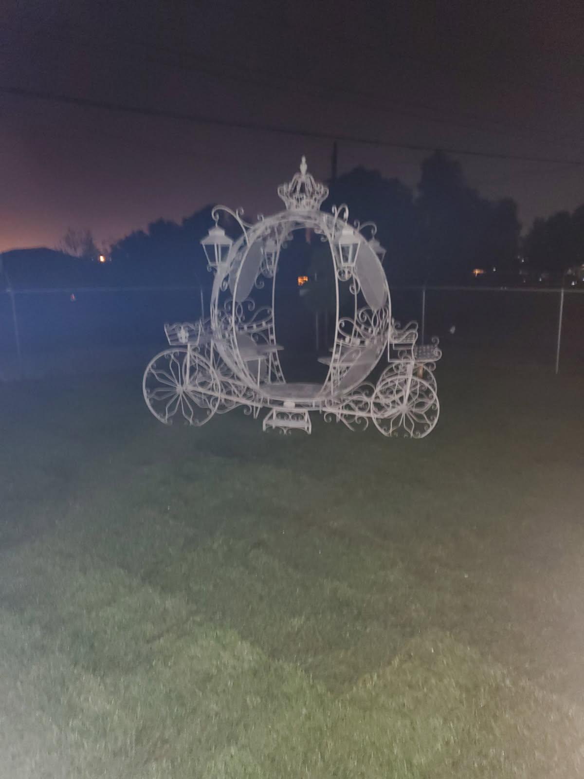Decorative metal carriage photographed at night